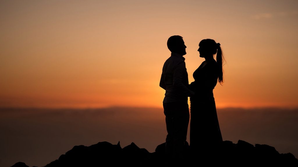 An ecstatic bride and groom embrace under a golden sunset, beautifully captured by the world's top wedding videographer, showcasing their unmatched storytelling and cinematography skills.