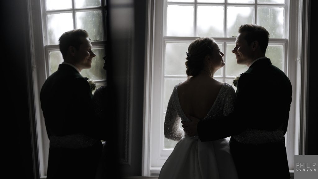 Just married couple standing in the window.