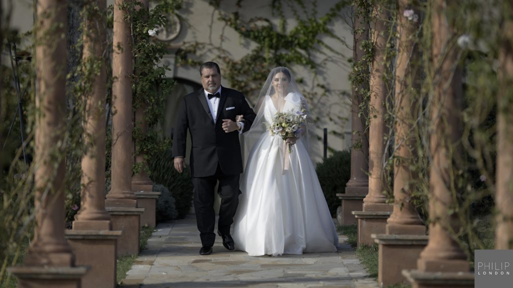 Father and bride walking down the aisle at her wedding.