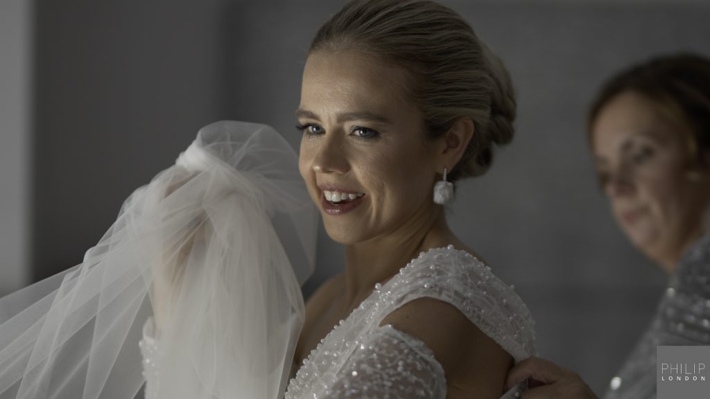 Bride with mum getting ready photograph