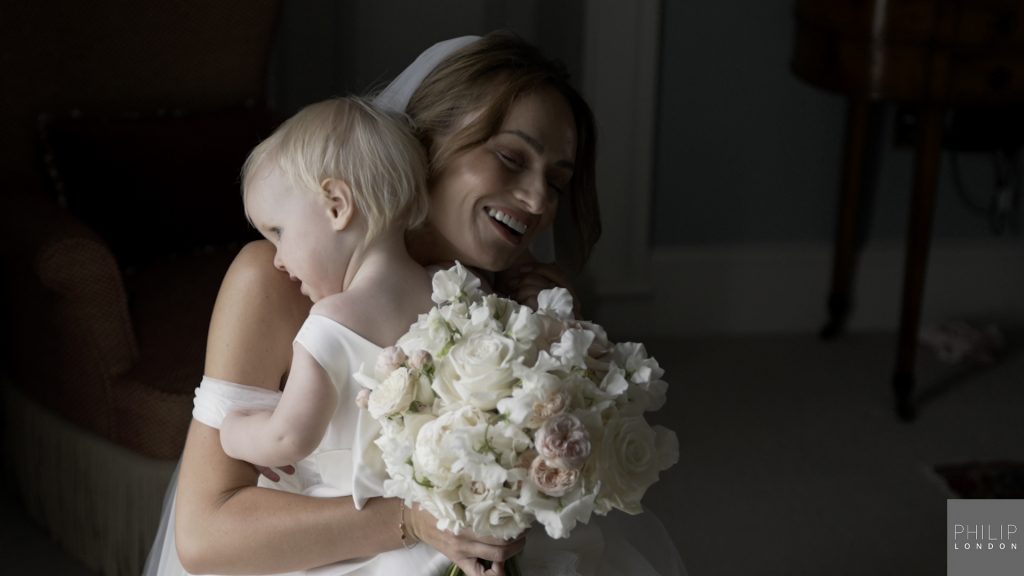 Bride giving daugher a hug.